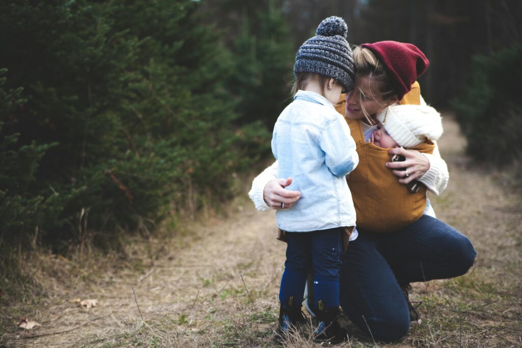 Mum with children , wearing baby carrier
Image Source: Pexels