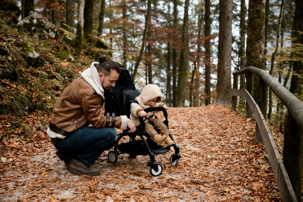 Dad and its baby in a baby stroller